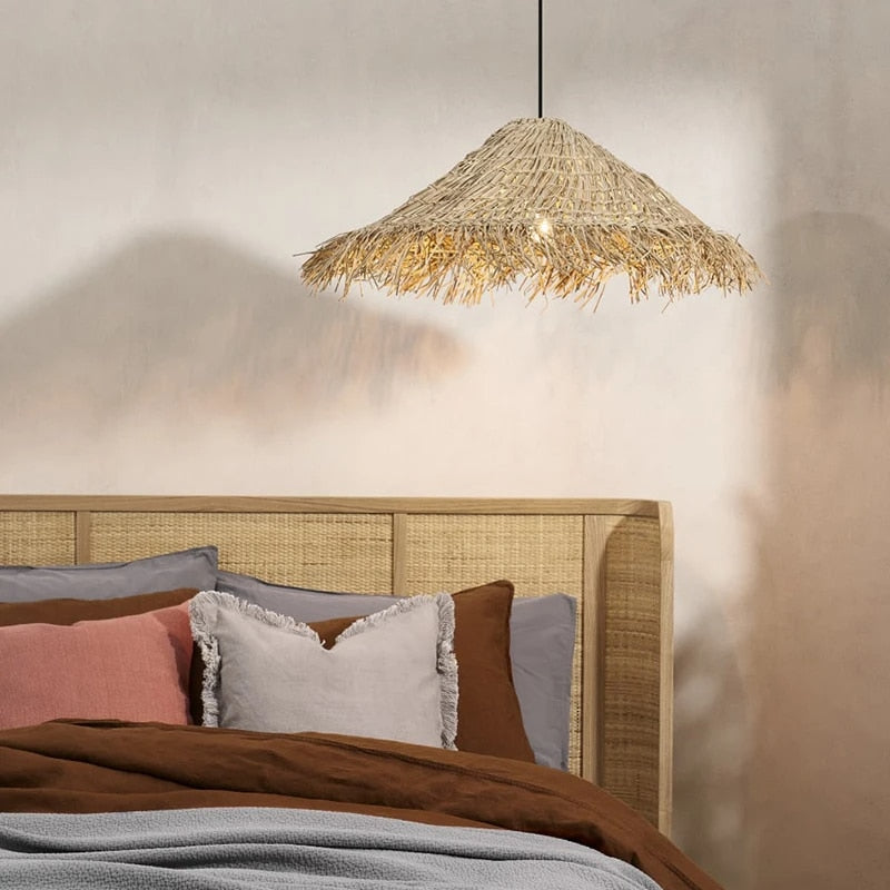 Asian-style handmade straw-look light with a dense weave – shown in a room setting