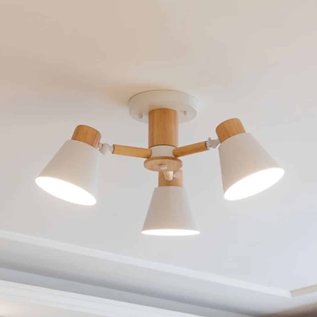 Modern three-arm LED chandelier with natural wood arms – close-up detail