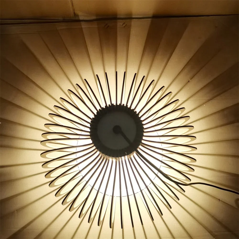 Modern light wood slat LED chandelier with a fine metal frame – close-up detail, lit