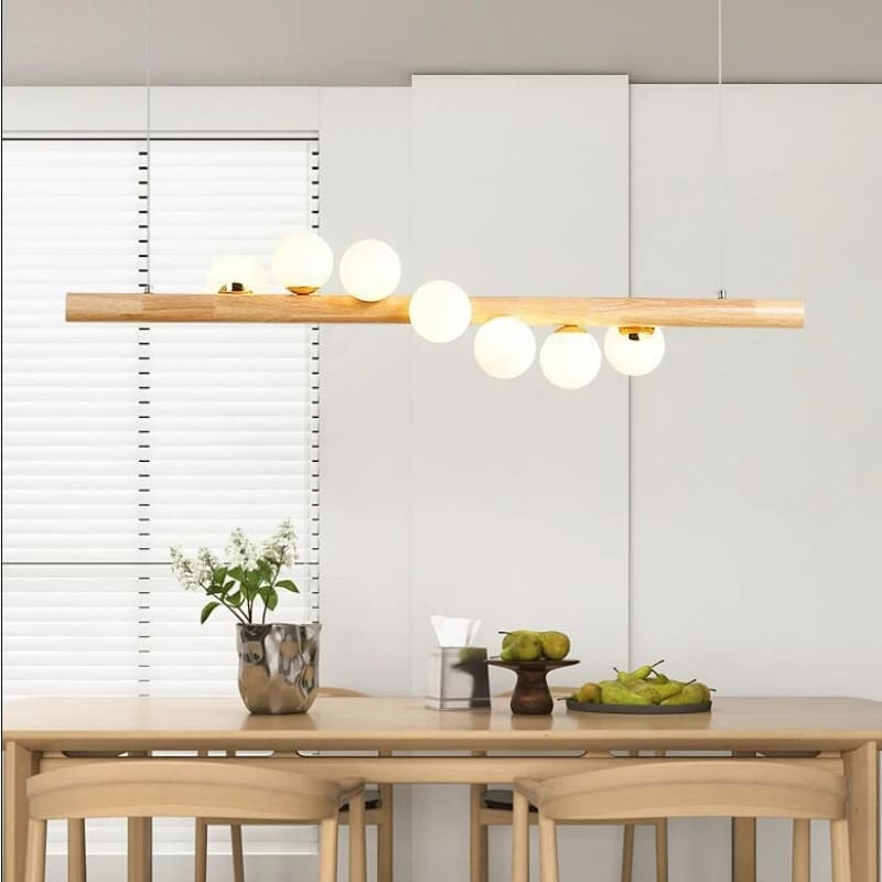 Nordic chandelier with seven frosted glass globes on a natural wood frame – shown in a room setting