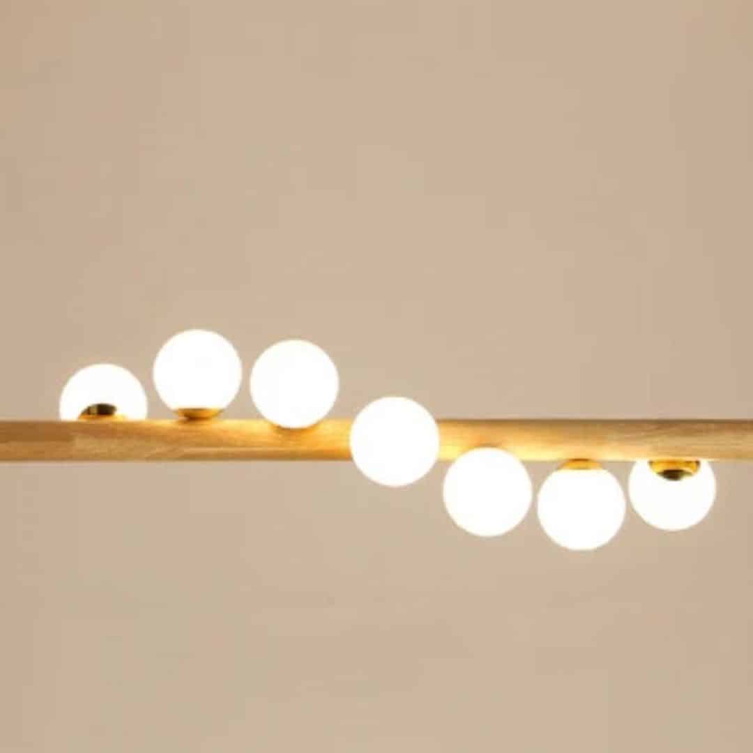 Nordic chandelier with seven frosted glass globes on a natural wood frame