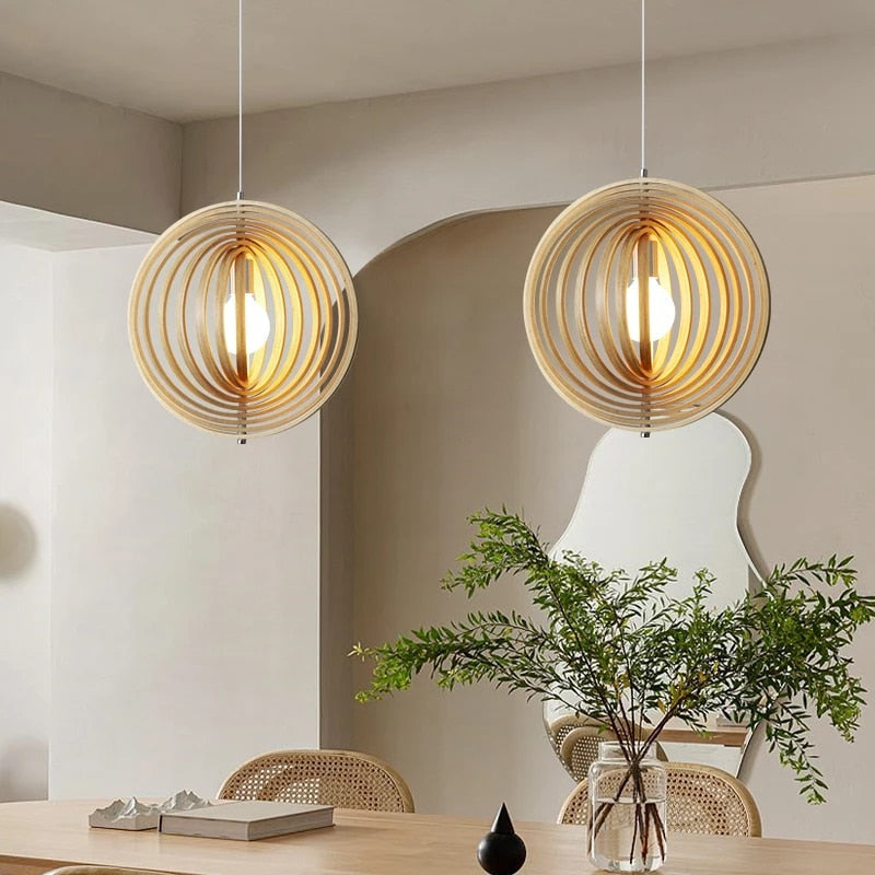 Japanese-style rotating chandelier with concentric natural wood slats – shown in a room setting
