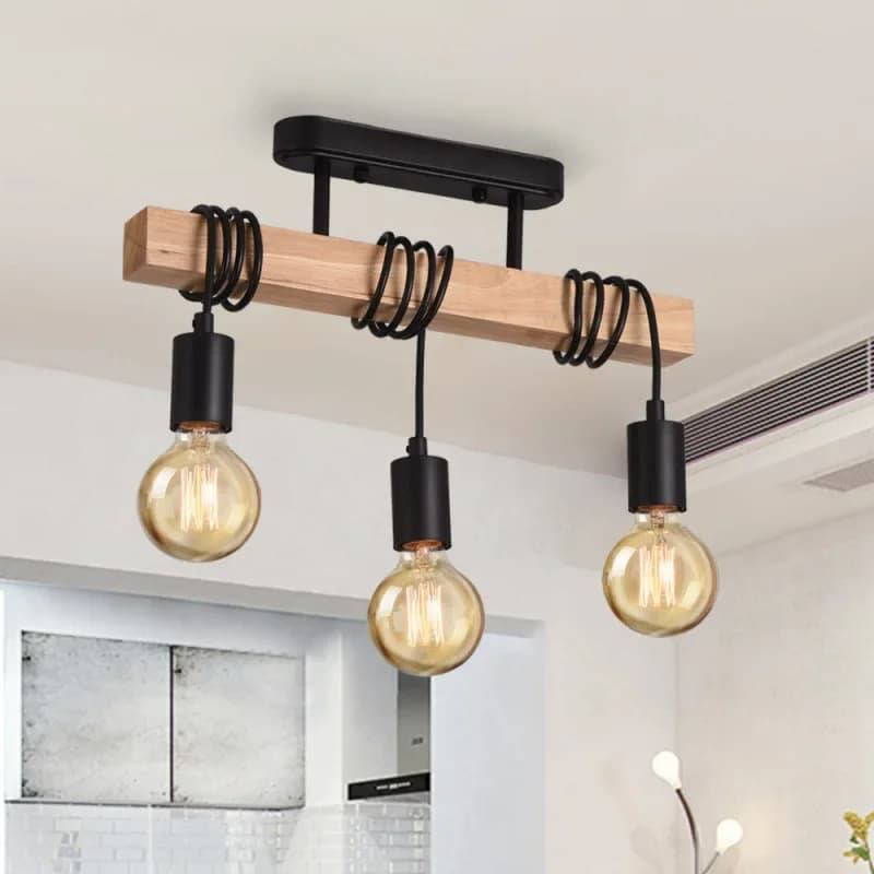 Retro three-light chandelier with patinated metal arms and turned wood sockets – shown in a room setting