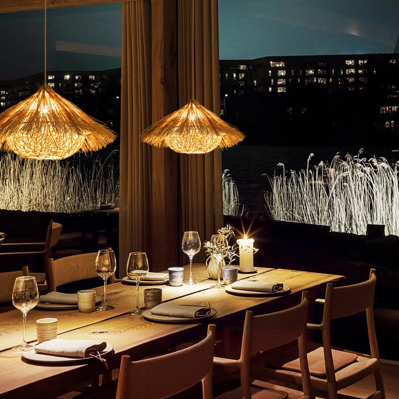 Round yellow bamboo and wood chandelier with an open circular structure – shown lit in a room setting (3)