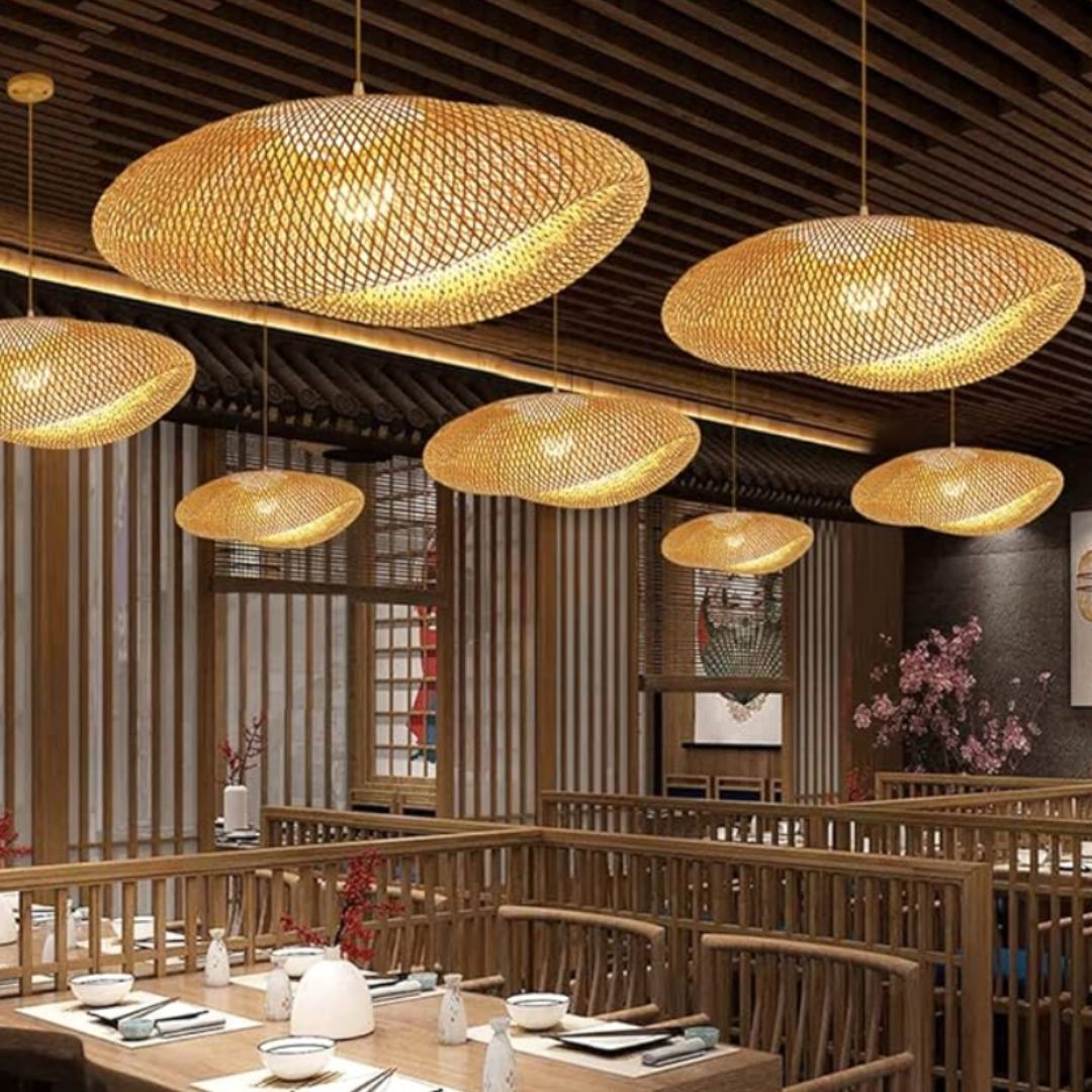 Wavy natural rattan chandelier with a golden tight weave – shown in a room setting