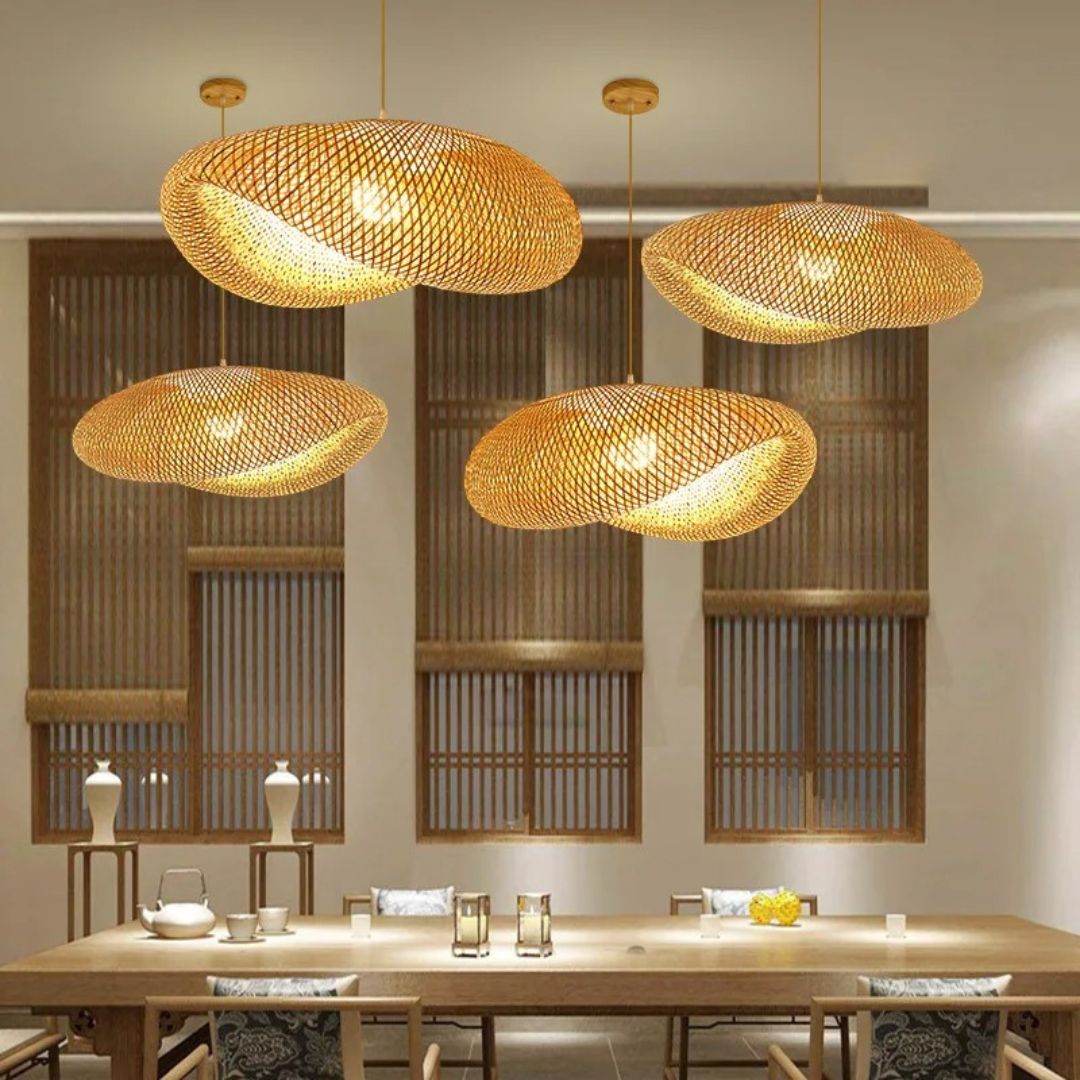 Wavy natural rattan chandelier with a golden tight weave – shown in a room setting (2)