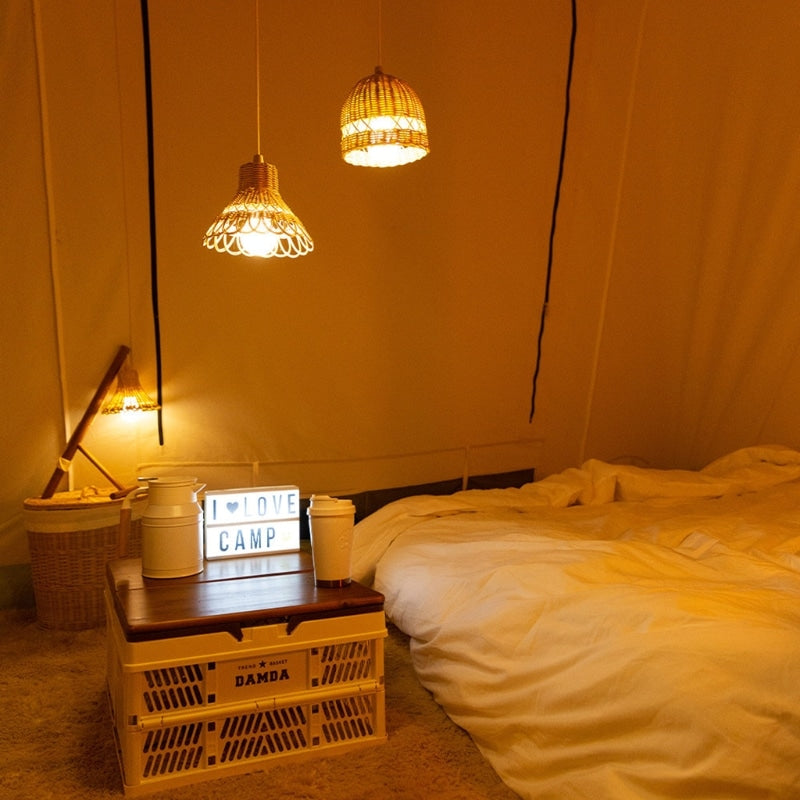 Antique-style Chinese rattan dome chandelier with a patinated finish – shown lit in a room setting