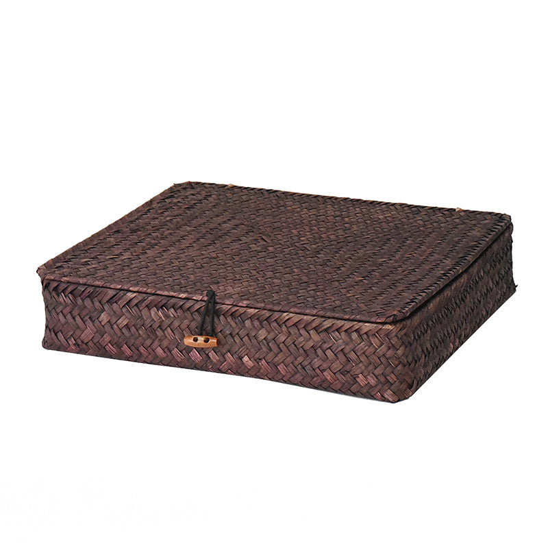 Low flat dark rattan storage trunk for under the bed