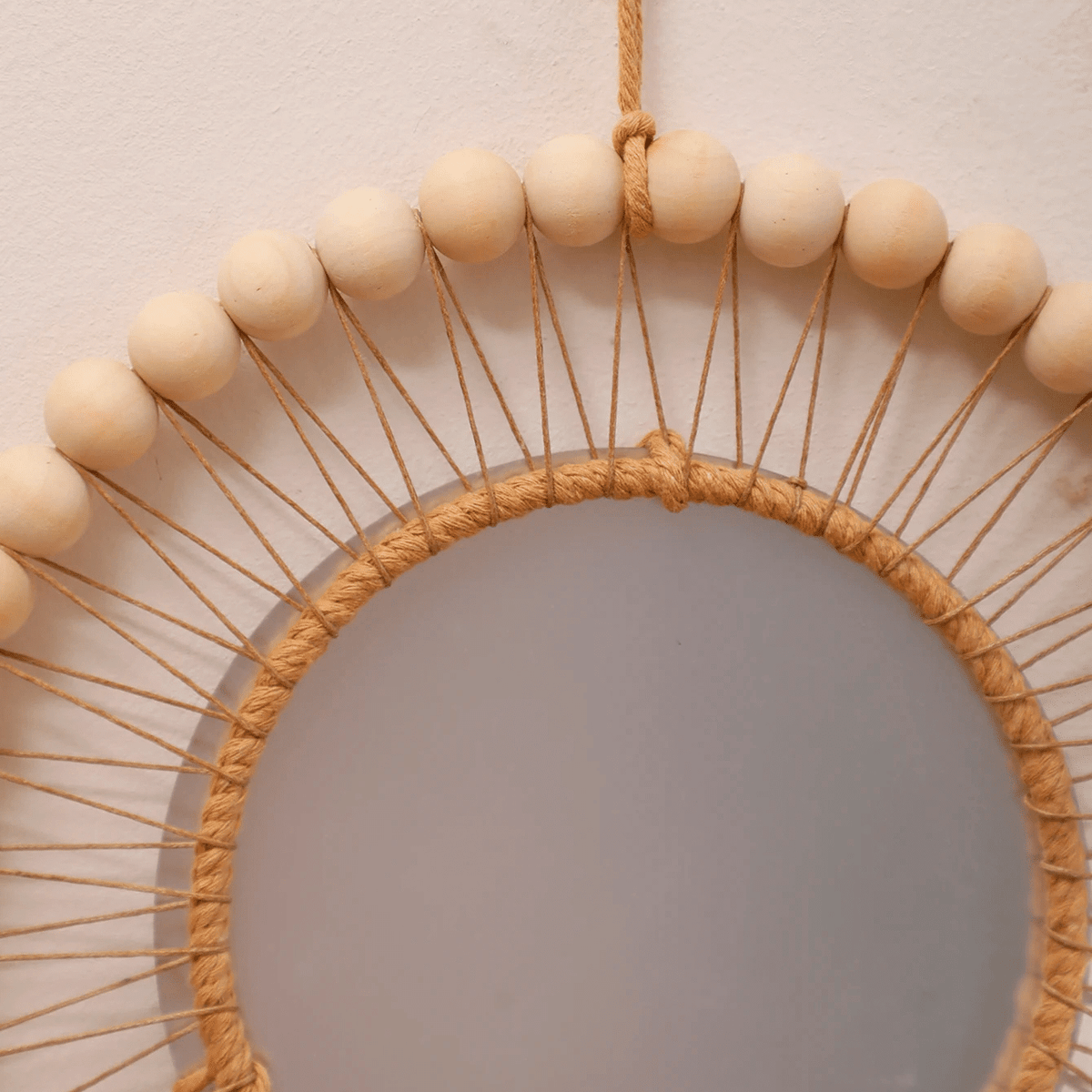 Wooden mirror with macramé fringe and hanging beads – close-up detail