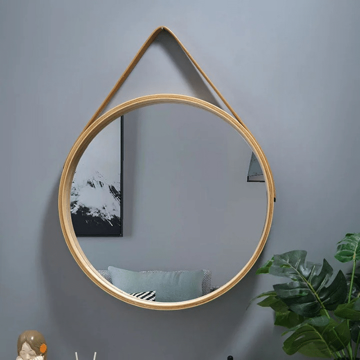 Round wooden mirror with a thick, grained border – shown in a room setting
