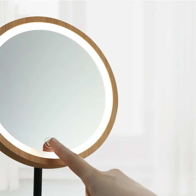 Swivel wooden vanity mirror with LED touch lighting – shown in use