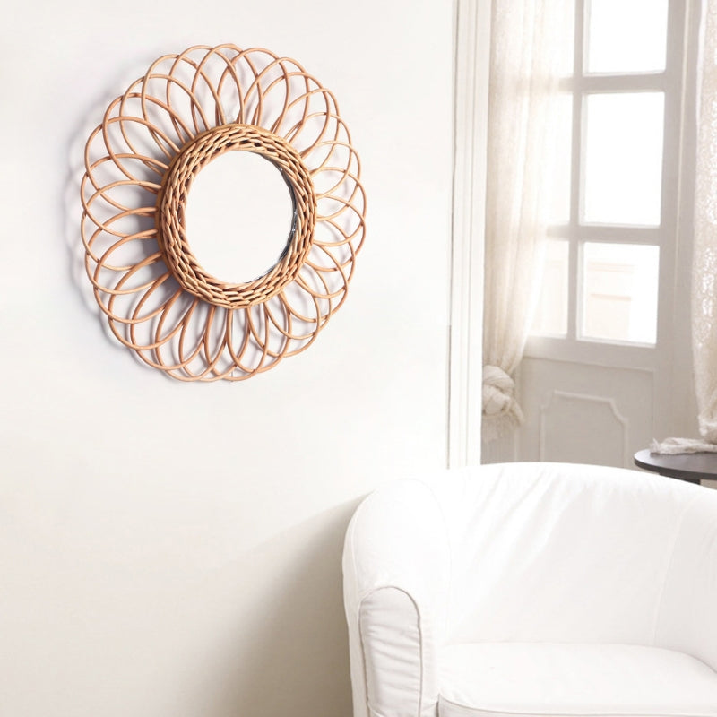 Spiral flower rattan mirror with handwoven petals – shown in a room setting
