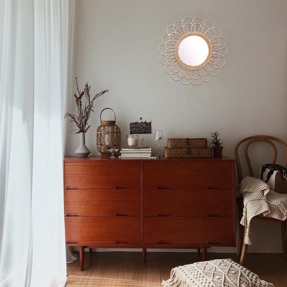 Large flower-shaped mirror with radiating natural rattan petals – shown in a room setting (2)