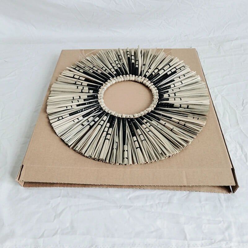 Round straw wall mirror with a tightly braided frame – close-up detail
