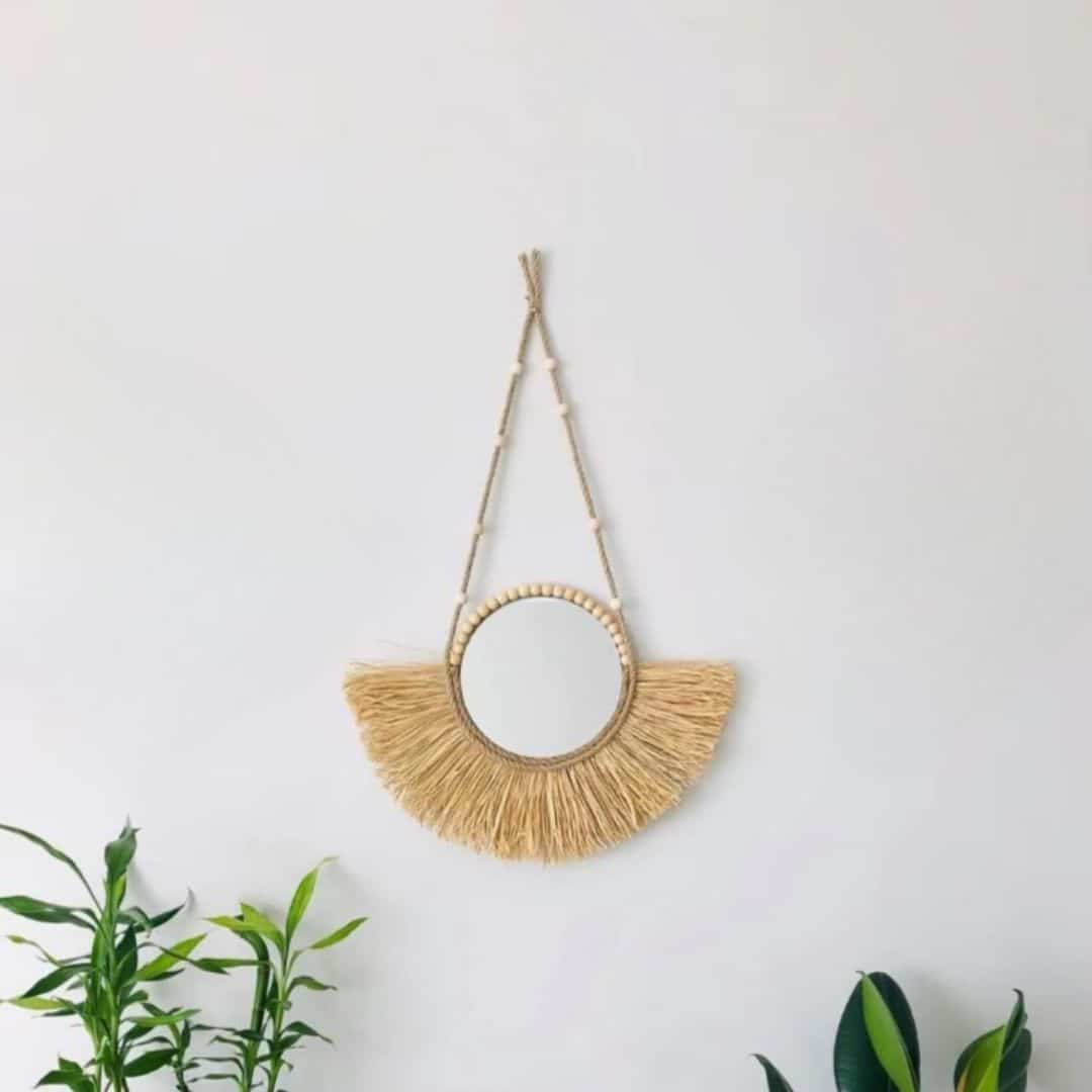 Round braided straw mirror edged with a trim of beads – shown in a room setting (2)