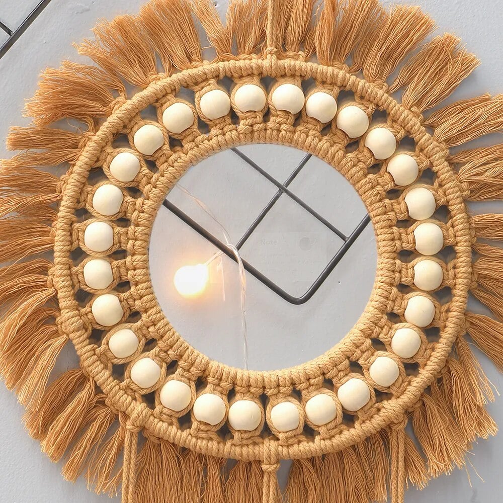 Round mirror with a braided rattan frame and cotton macramé fringe – close-up detail