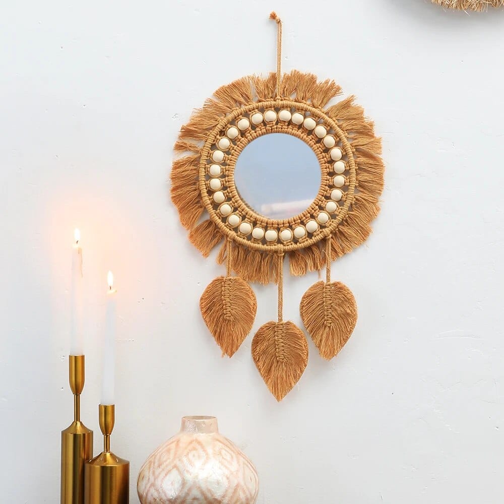 Round mirror with a braided rattan frame and cotton macramé fringe