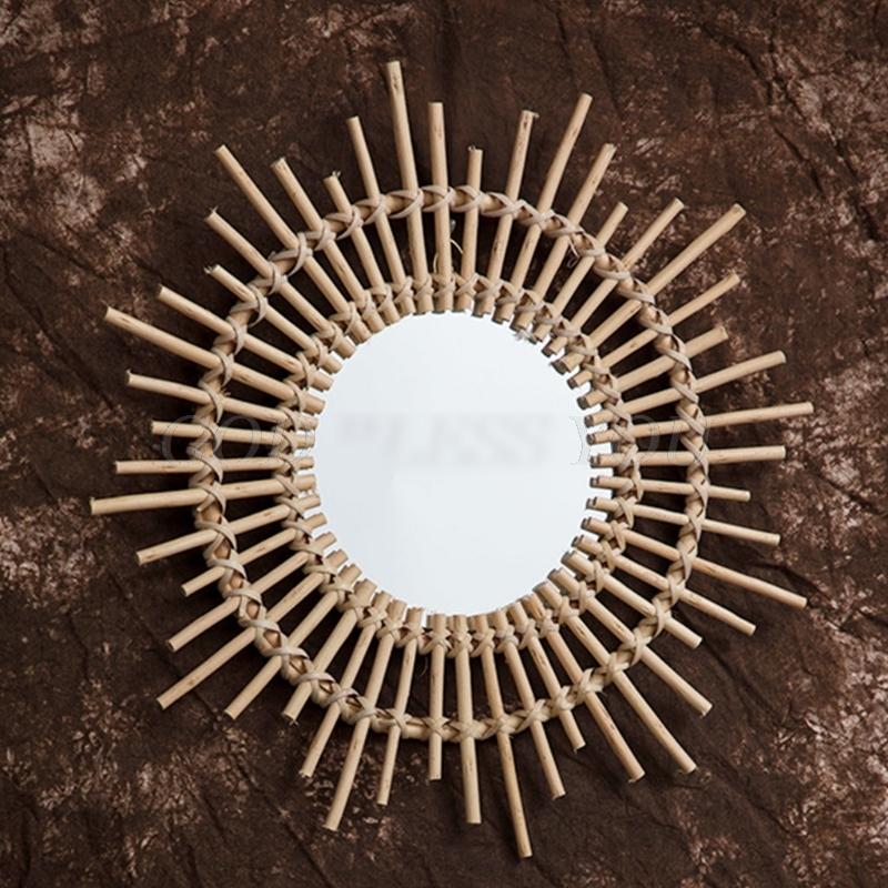 Rattan sun wall mirror with hand-braided rays of varied lengths – shown in a room setting