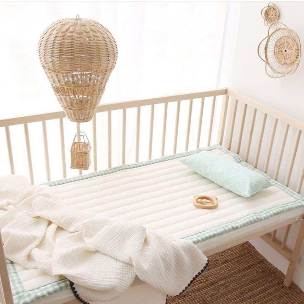 Hand-woven rattan hot air balloon nursery decor – shown in a room setting