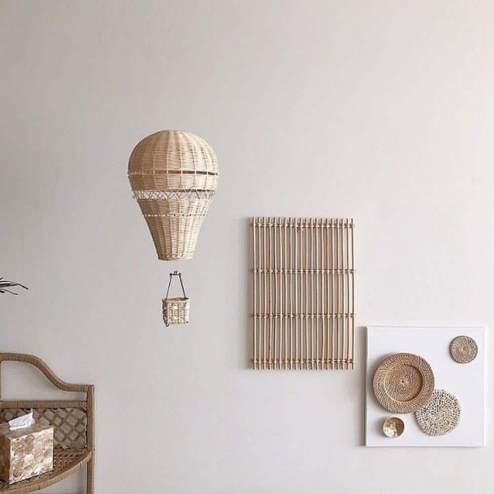 Hanging rattan hot air balloon decor – shown in a bedroom