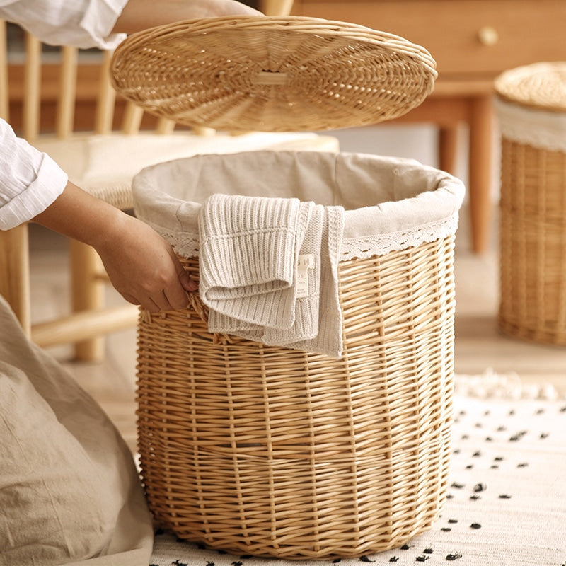 Hand-braided rattan laundry basket with a removable lid and handles – shown in use