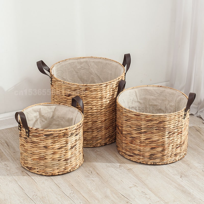 Rattan laundry basket with two handles woven into its structure – shown in a room setting
