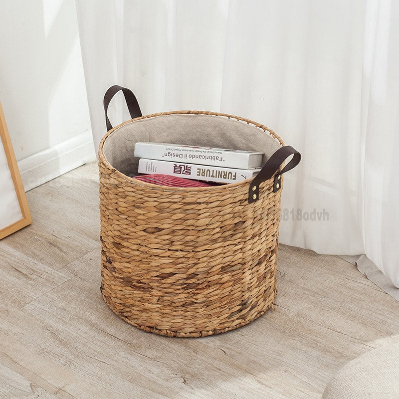 Rattan laundry basket with two handles woven into its structure – shown in a room setting (4)