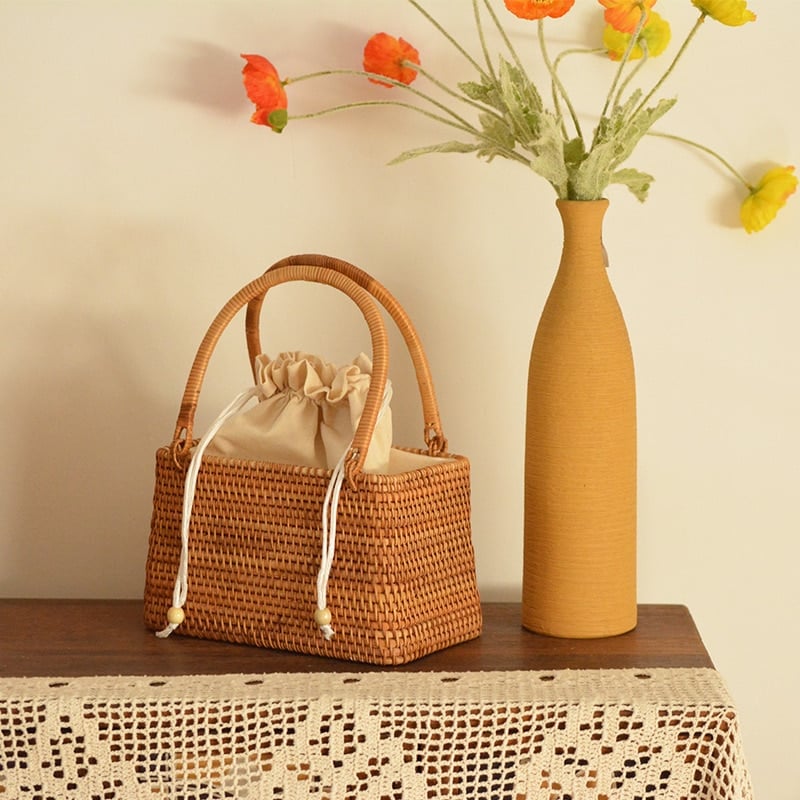 Vintage round rattan basket bag with generous handles – shown in a room setting