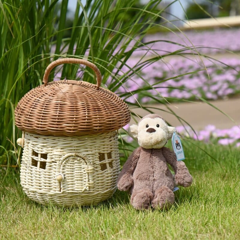 Handwoven rattan storage basket shaped like a little house – shown outdoors