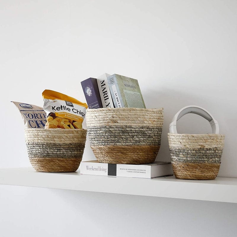 Woven rattan storage basket with integrated handles – shown in a room setting (3)