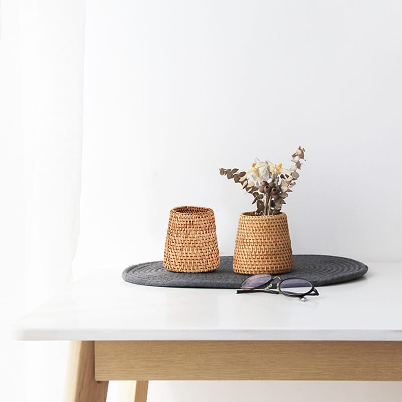 Golden woven rattan household basket – shown in a room setting