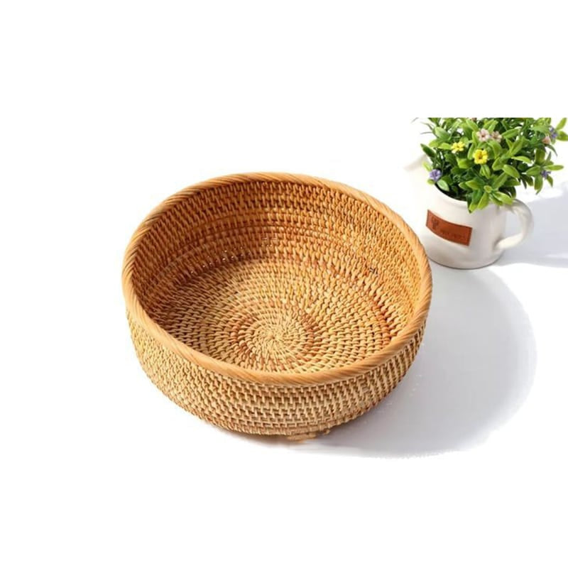 Round woven storage basket in natural rattan and plant fibers
