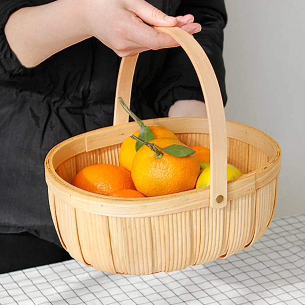 Beige round wicker-look fruit and vegetable basket – shown in a room setting