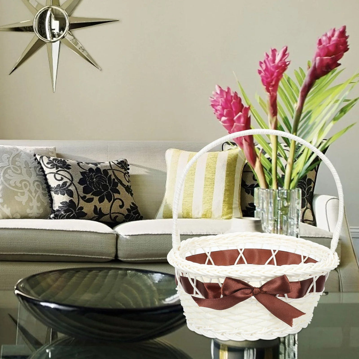 Ivory wicker-look basket with a brown ribbon and handle – shown in a room setting