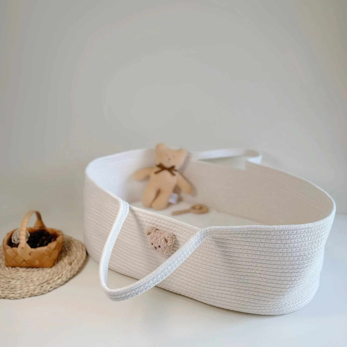 Wicker-look changing basket with a teddy bear head on the side – shown in a room setting
