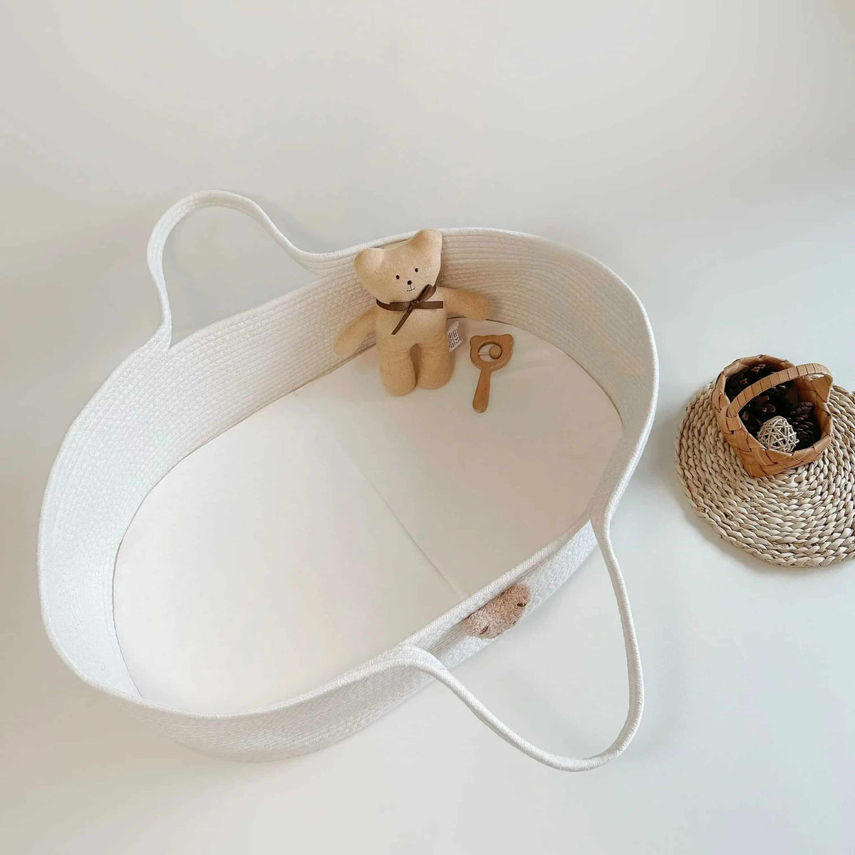 Wicker-look changing basket with a teddy bear head on the side