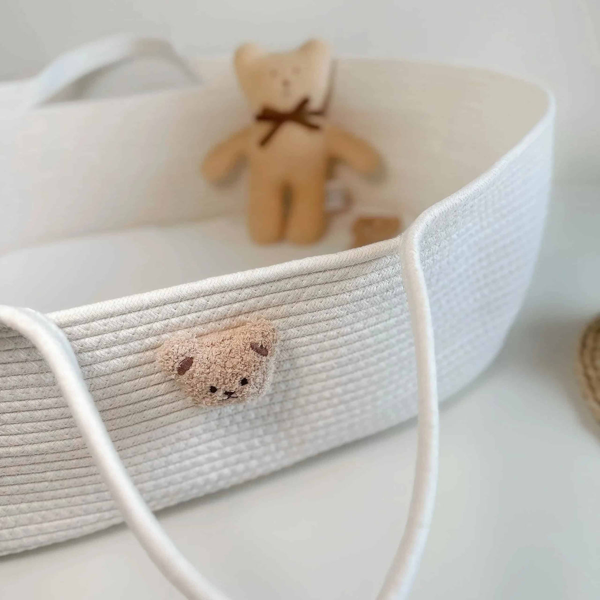 Wicker-look changing basket with a teddy bear head on the side – shown in a room setting (2)