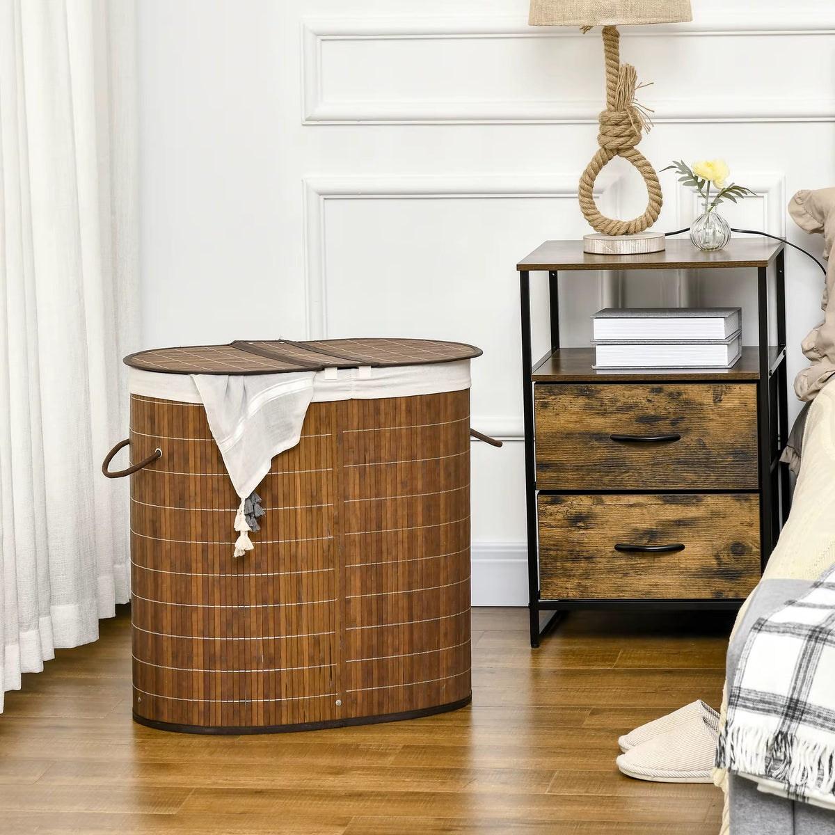 Two-compartment rattan and bamboo laundry basket – shown in a room setting