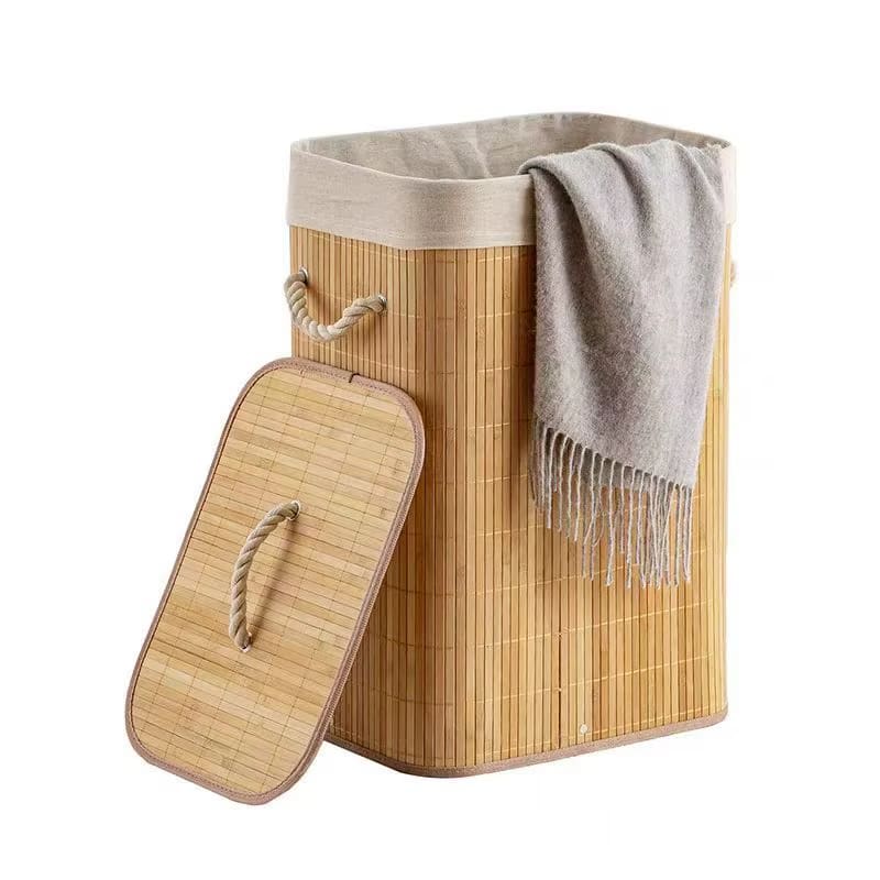 Rattan and bamboo laundry basket with sturdy handles – shown in a room setting