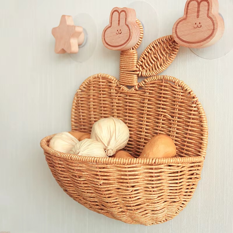 Apple-shaped rattan wall basket with an openwork weave – shown in a room setting