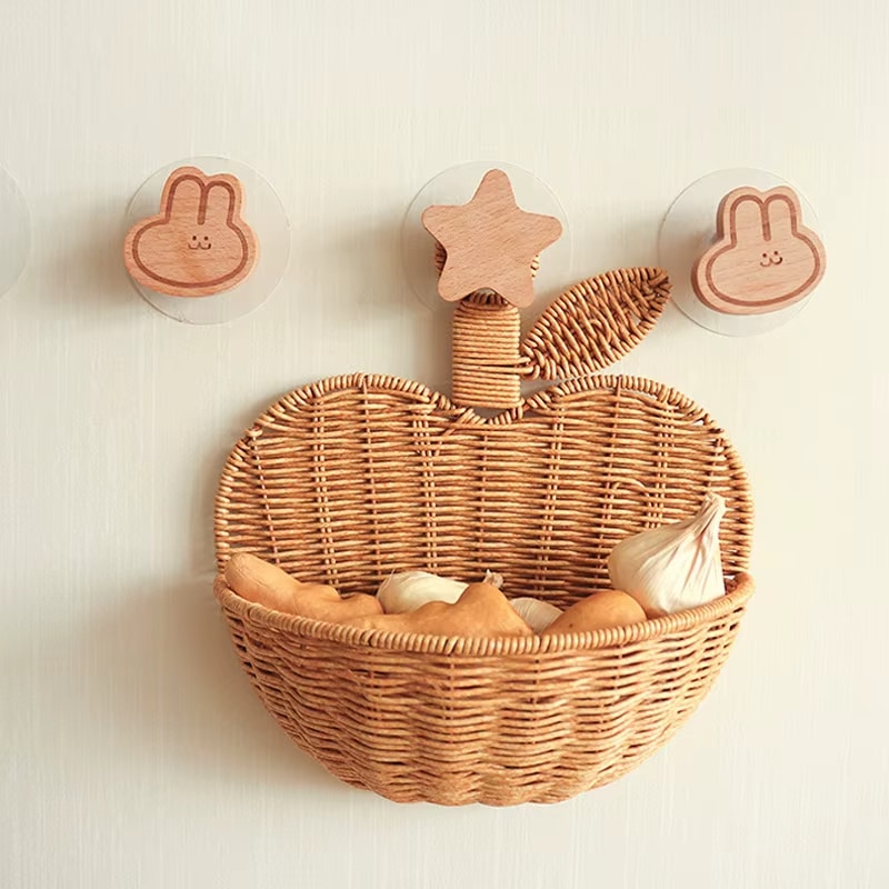 Apple-shaped rattan wall basket with an openwork weave – shown in a room setting (2)