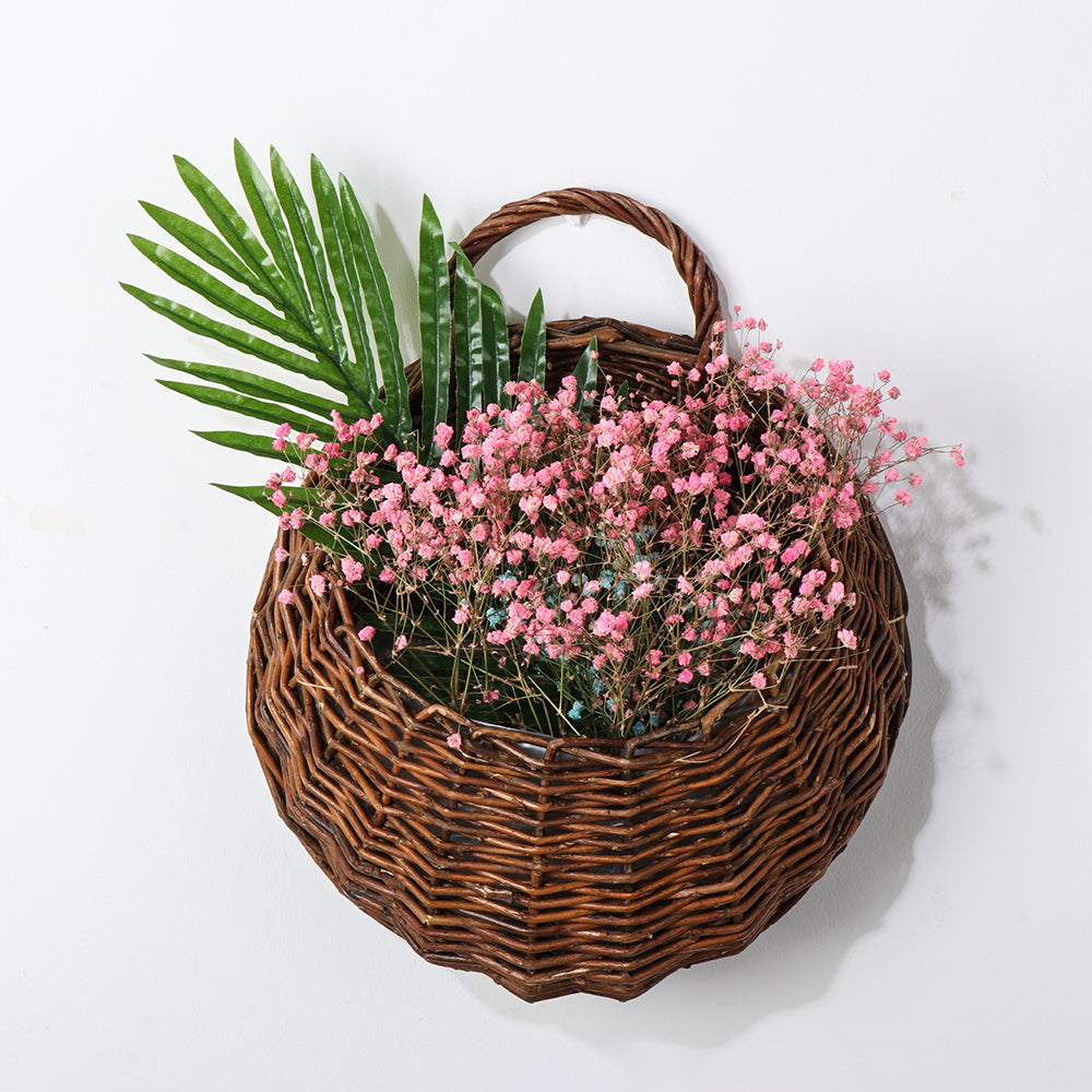 Black handmade rattan and wicker plant holder – shown in a room setting