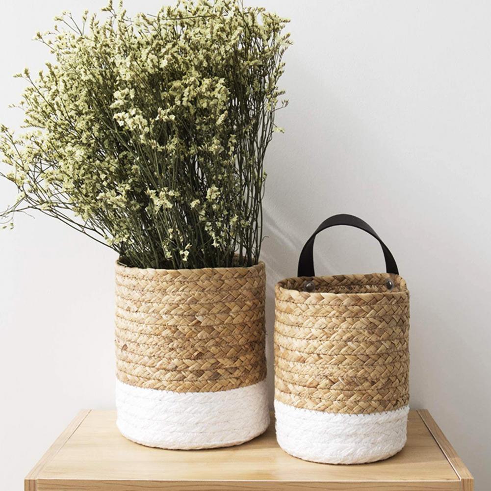 Hand-braided hanging rattan plant basket – shown in a room setting