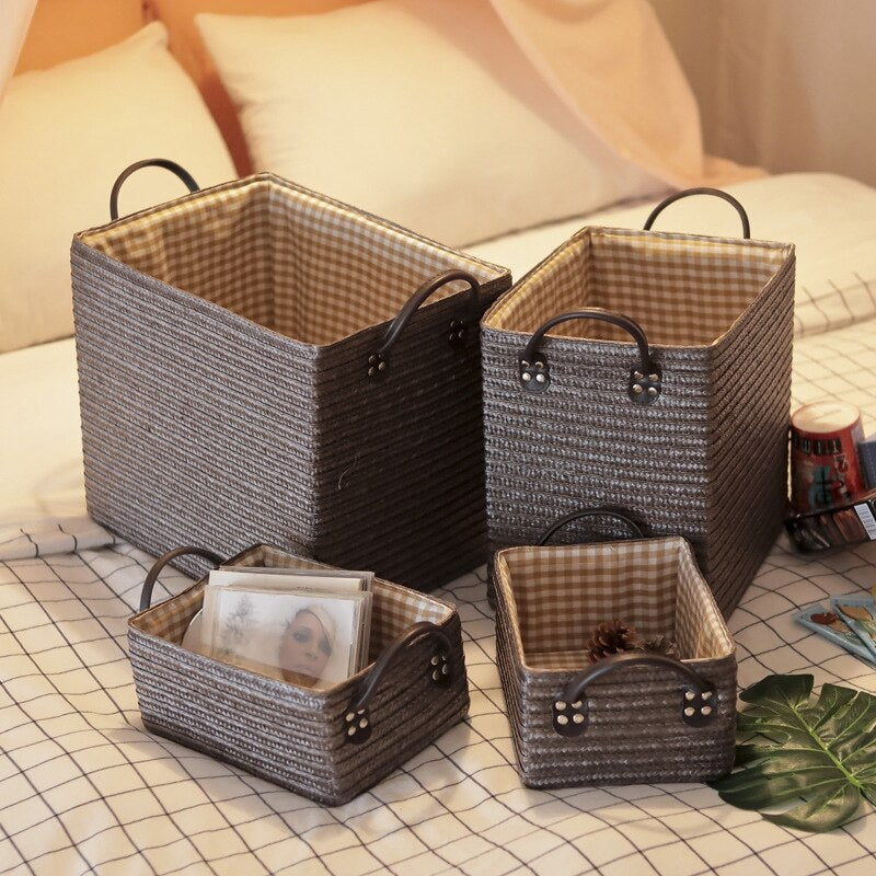 Square hand-braided rattan box basket with two handles – shown in a room setting (2)