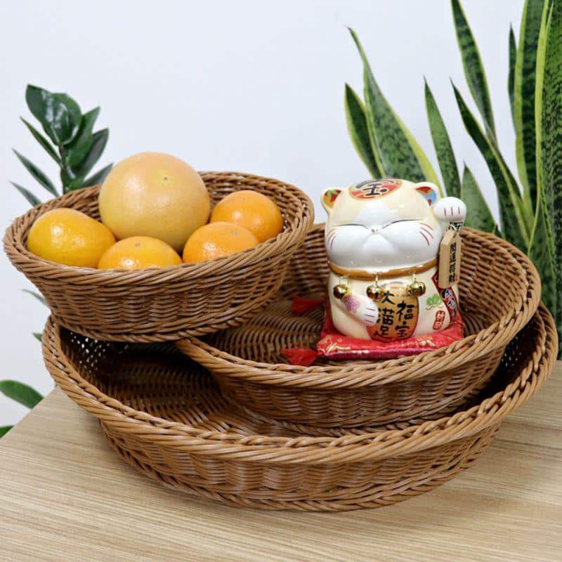 Round handwoven rattan display basket – shown in a room setting