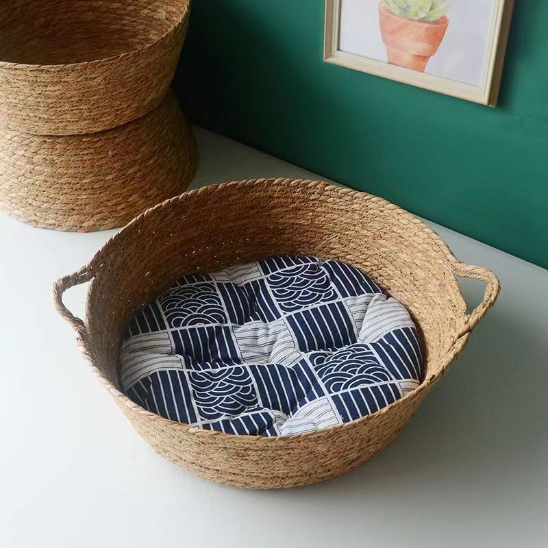 Hand-braided rattan dog bed with a soft removable cushion – shown in a room setting