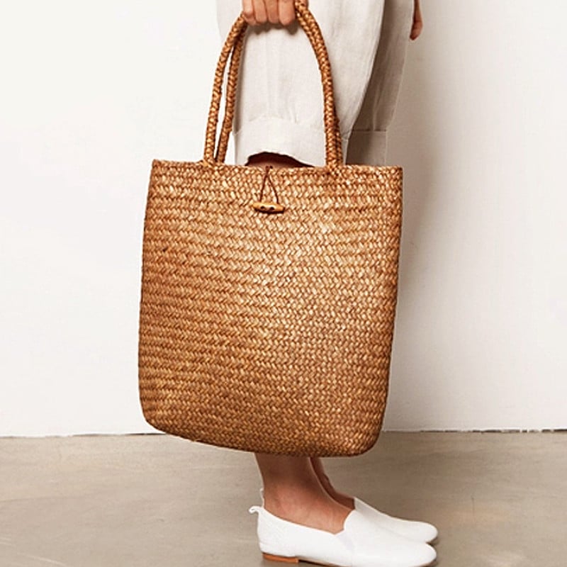 Handmade rattan shoulder basket bag with an adjustable strap – worn by a model (2)