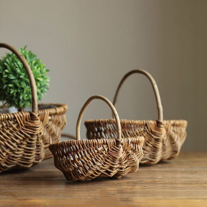 Round woven catchall basket with golden highlights – shown in a room setting