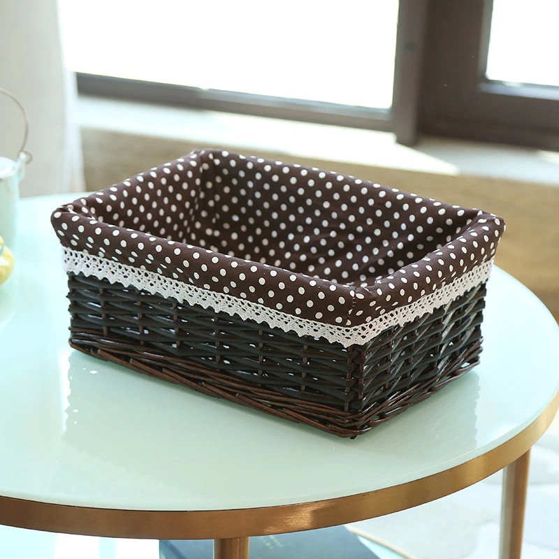 Rectangular rattan storage basket with a removable cotton liner – black variant, shown in a room setting