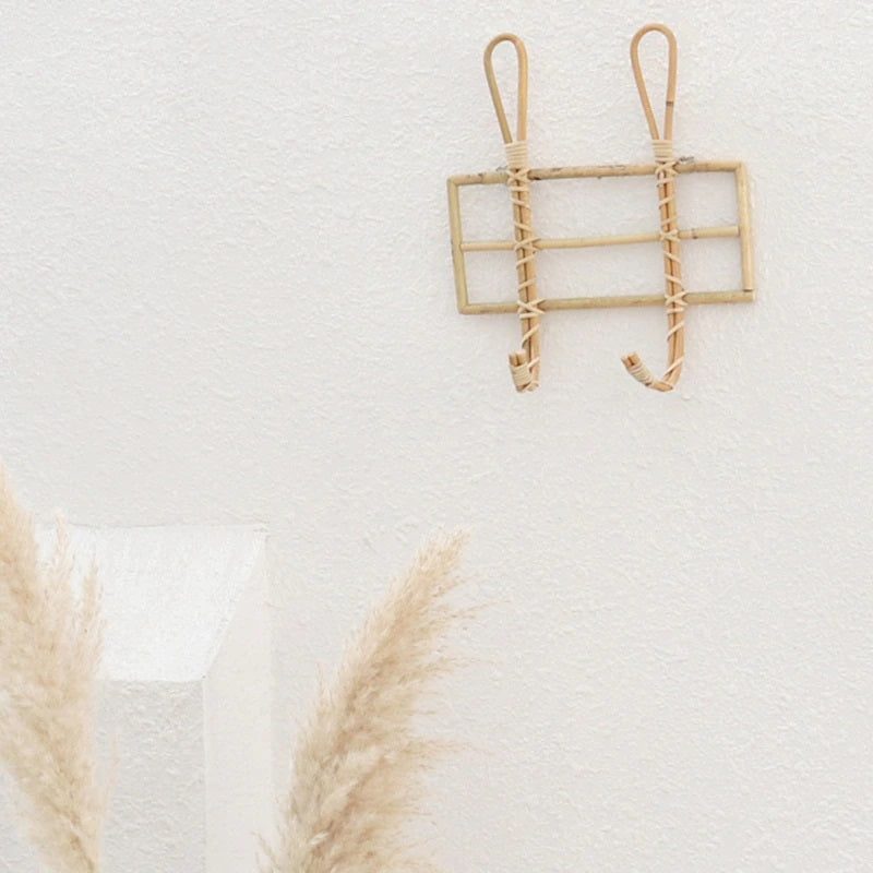 Rustic natural rattan wall rack with two hooks – shown in a room setting